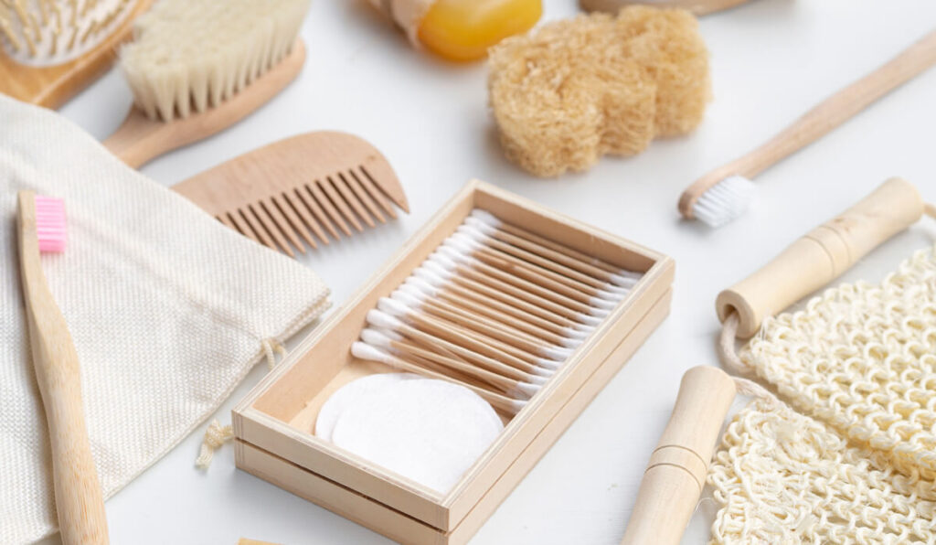 Alternatives to daily essentials of plastic products that includes bamboo tooth brush, bamboo comb, jute bags, bamboo brush, and loofah.