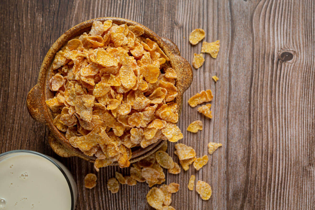 image of organic corn flakes in a wooden bowl