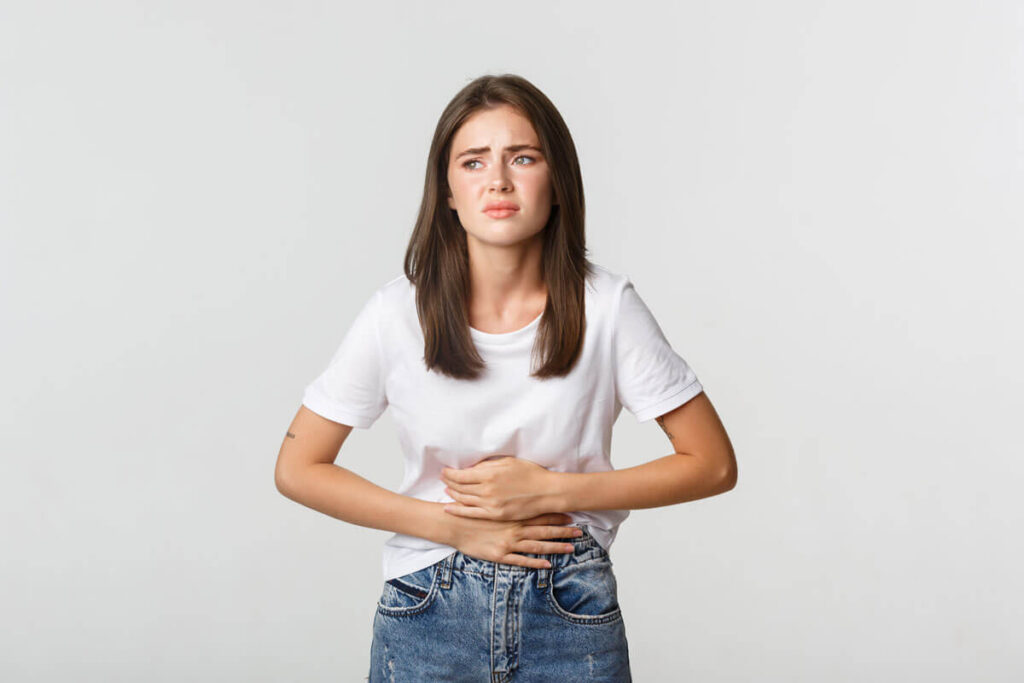 image of woman holding her belly showing constipation